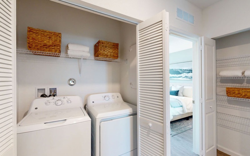 washer and dryer with shelves above