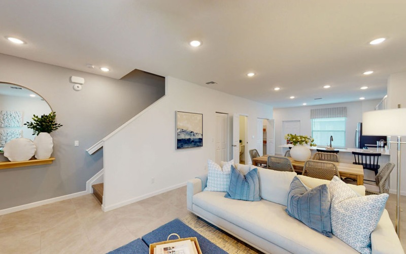 living room with a couch and view of the kitchen