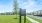 A large lawn with a sign and cars